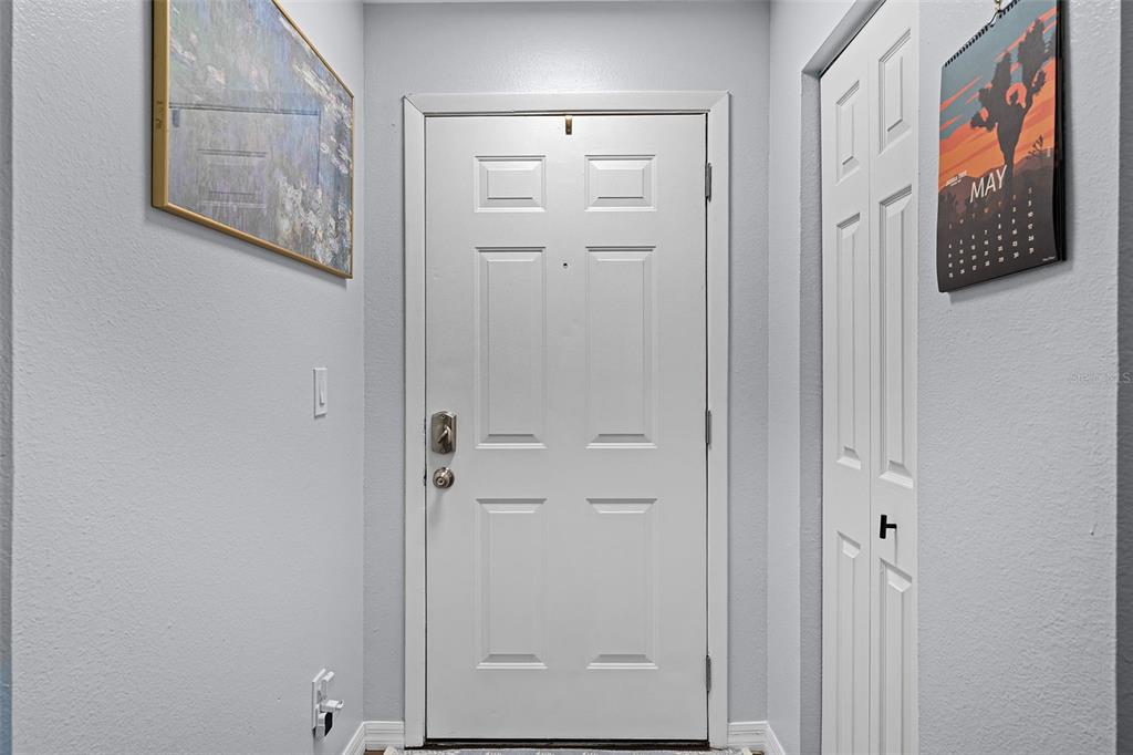 A white front door is centered in a small entryway with light gray walls — 3028 PARKWAY BOULEVARD UNIT 308, KISSIMMEE, FL