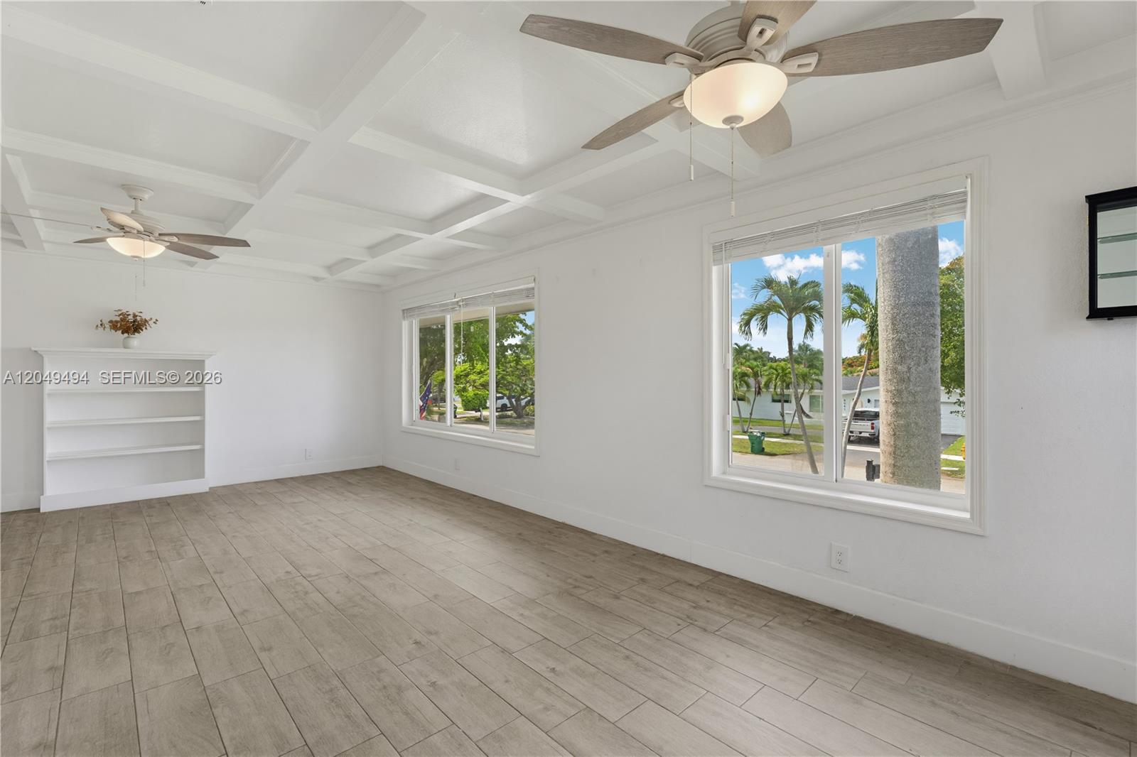 A bright living room features a coffered ceiling, wood-look tile floors, and two large windows — 8020 SW 198th St, Cutler Bay FL 33189, CUTLER BAY, FL