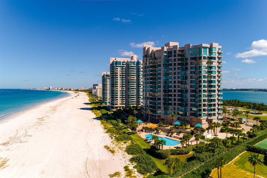 An aerial view of high-rise residential buildings situated along a sandy beach and ocean — 1560 GULF BOULEVARD UNIT 1507, CLEARWATER BEACH, FL