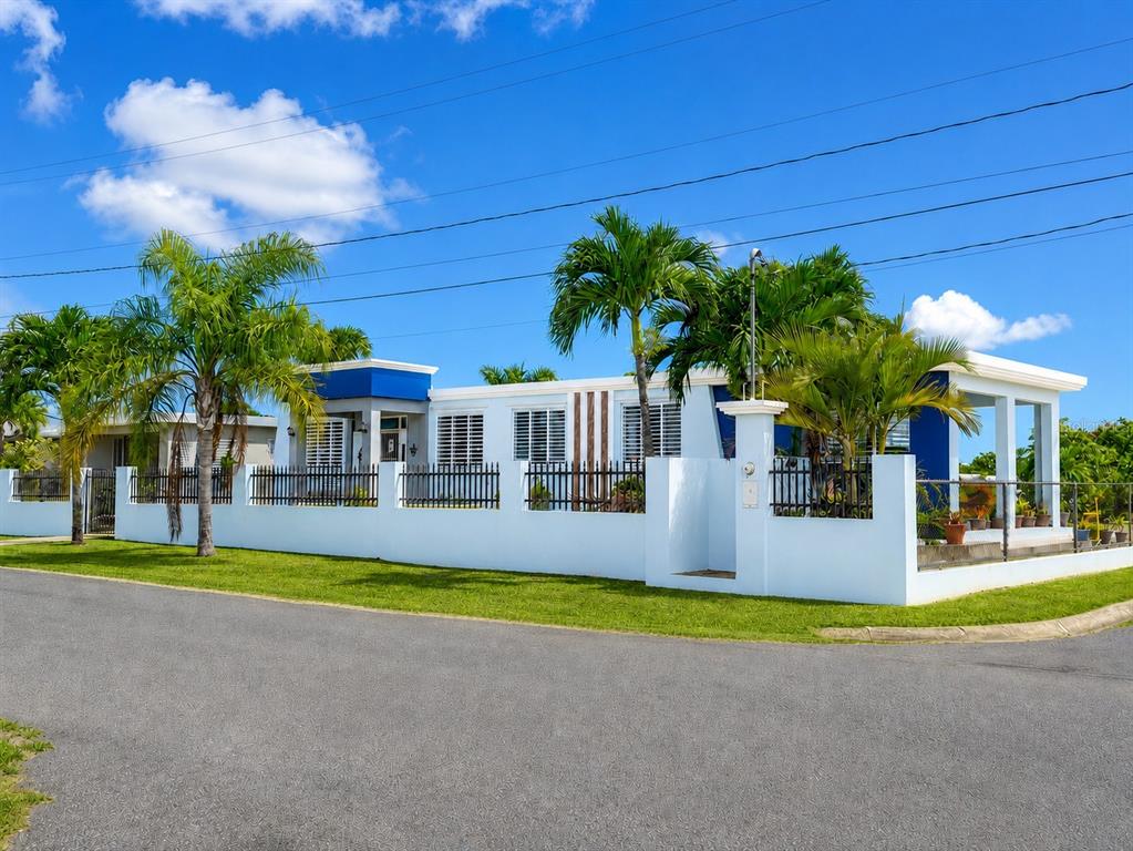 A white house with blue accents and palm trees behind a low perimeter wall — 467 BARRIO CAMASEYES, AGUADILLA, KM 4.8 INT, AGUADILLA, PR