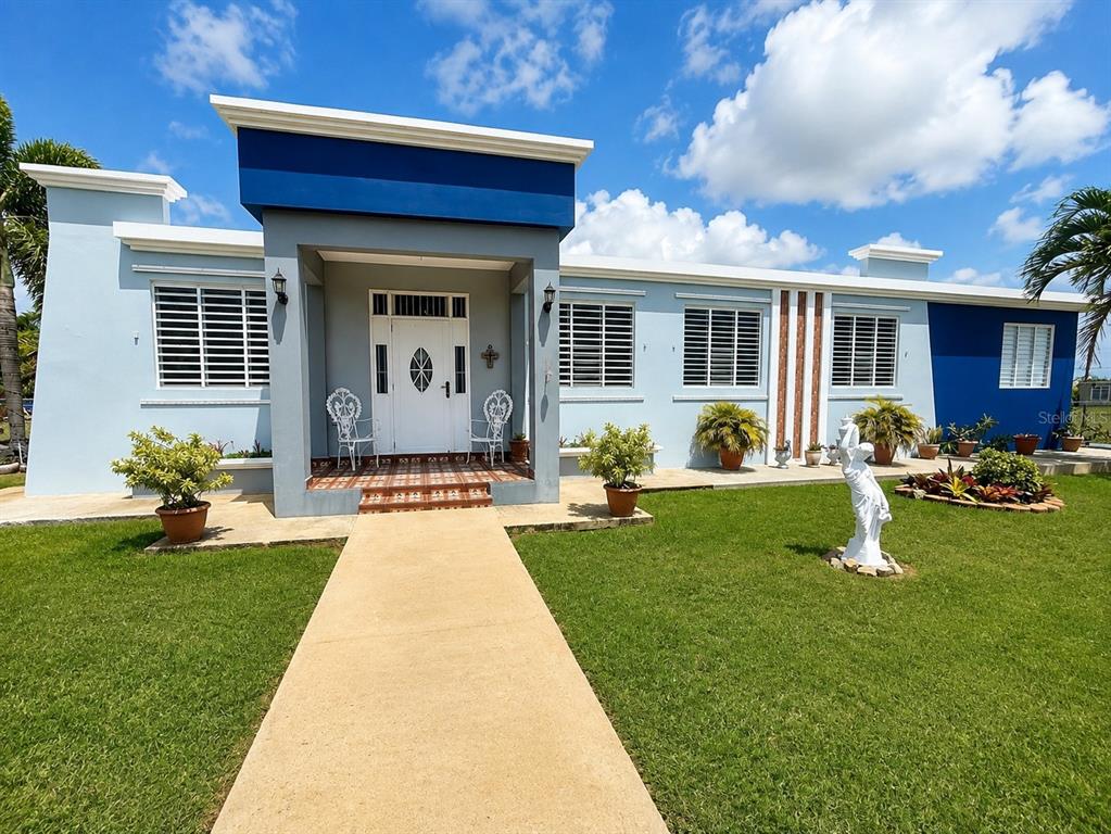 A light blue single-story house with a dark blue accent wall and a concrete walkway — 467 BARRIO CAMASEYES, AGUADILLA, KM 4.8 INT, AGUADILLA, PR