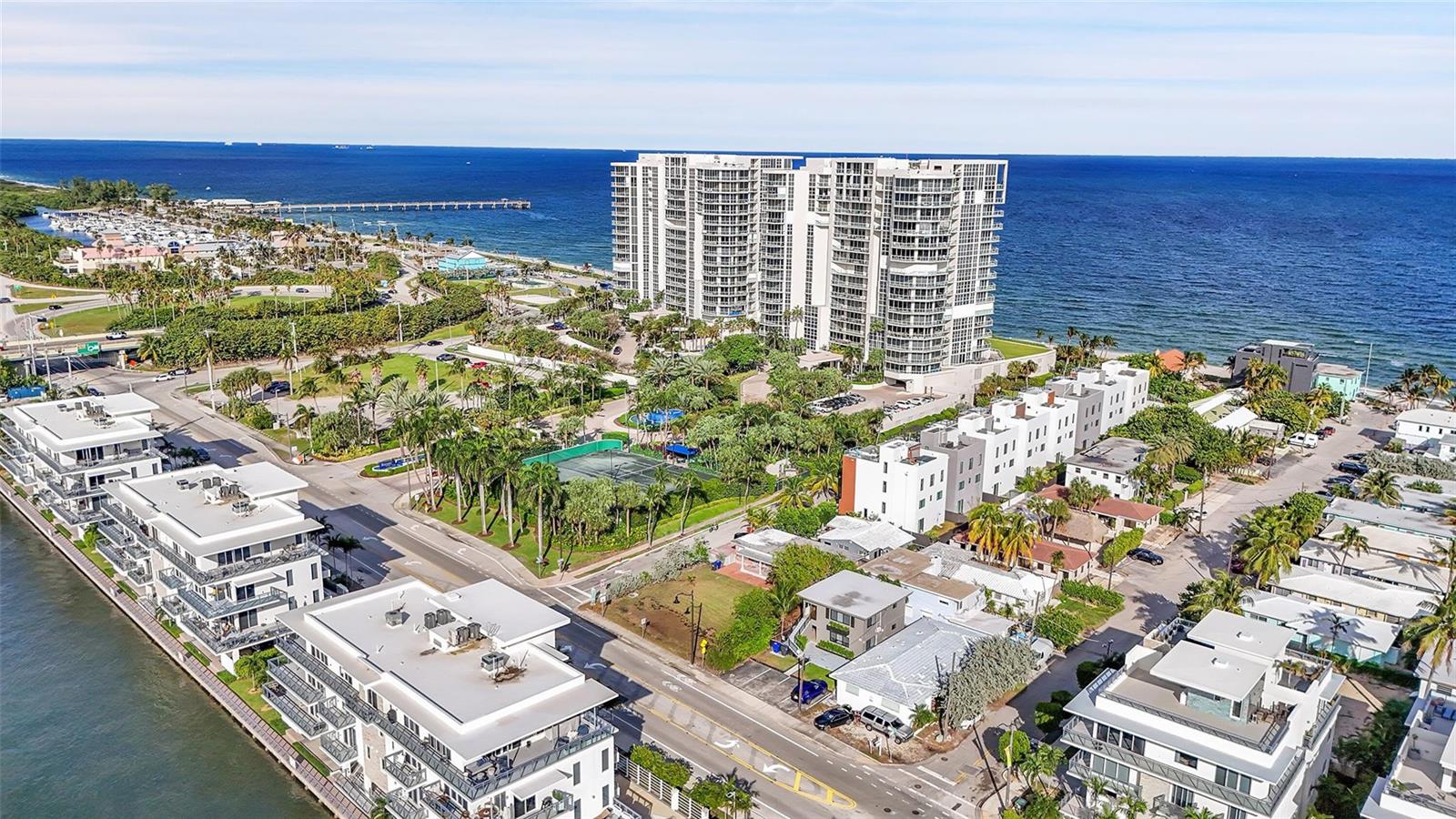 An aerial view shows a coastal neighborhood with modern apartment buildings, a park, and oceanfront — 356 Balboa Street, Hollywood FL 33019, HOLLYWOOD, FL
