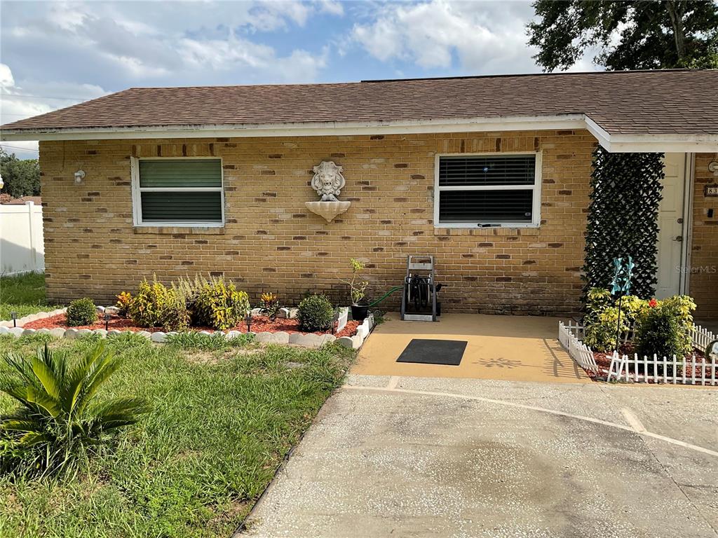 A single-story brick house features a lion head wall fountain and a concrete driveway — 837 CAMPELLO STREET, ALTAMONTE SPRINGS, FL