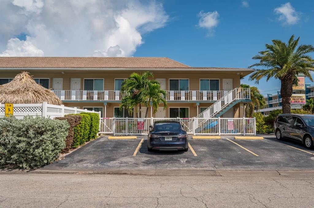 A two-story motel building with a parking lot and palm trees in front — 14251 GULF BOULEVARD UNIT 12, ST PETERSBURG, FL