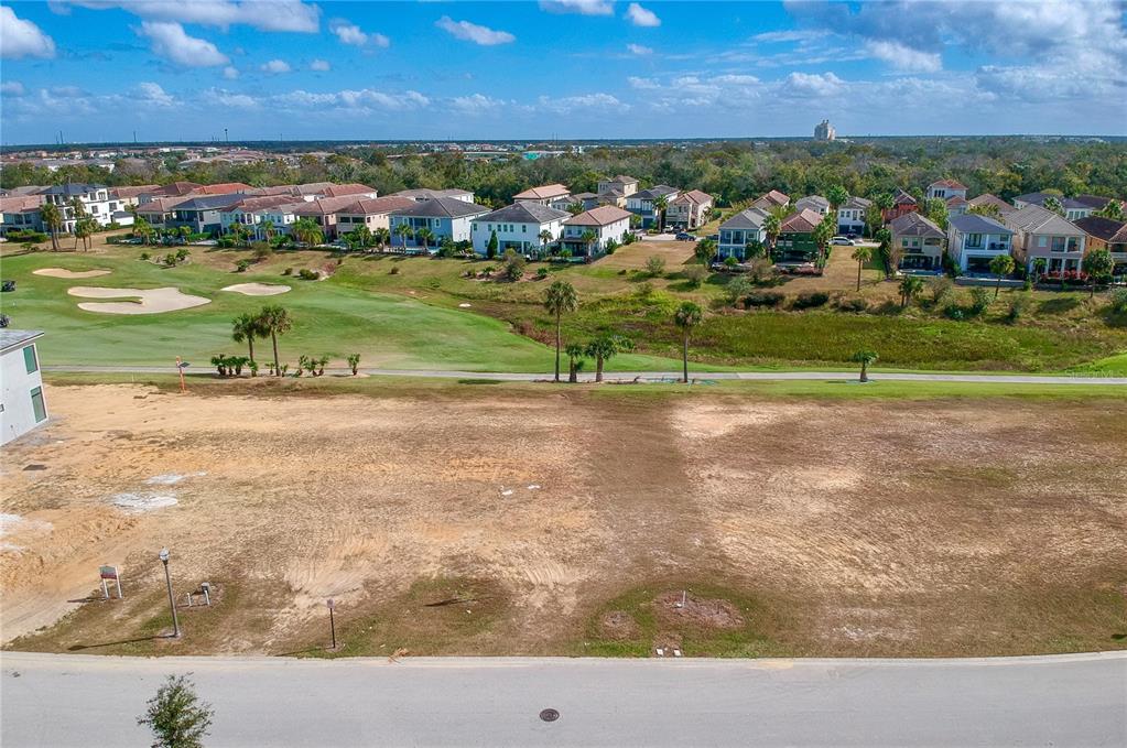 An elevated view of a vacant, cleared residential lot overlooking a golf course and houses — 1161 GRAND TRAVERSE PARKWAY, REUNION, FL