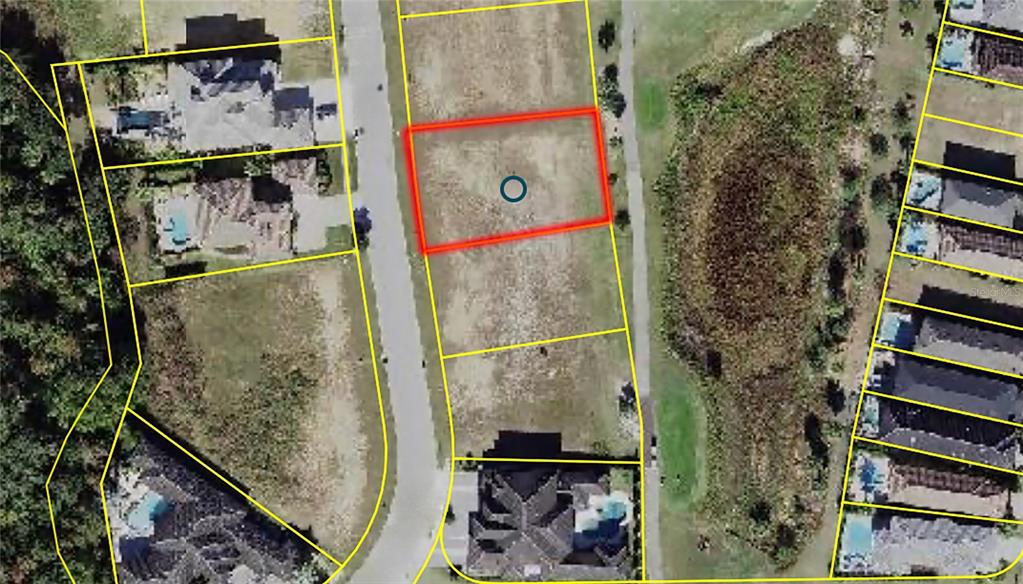An aerial view shows a vacant rectangular residential lot highlighted in red — 1161 GRAND TRAVERSE PARKWAY, REUNION, FL