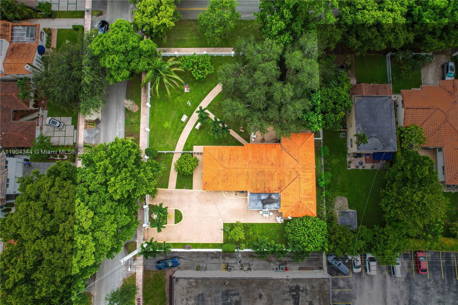 An aerial view shows a house with an orange tile roof, large yard, and driveway — 1407 San Marco Ave, Coral Gables FL 33134, CORAL GABLES, FL