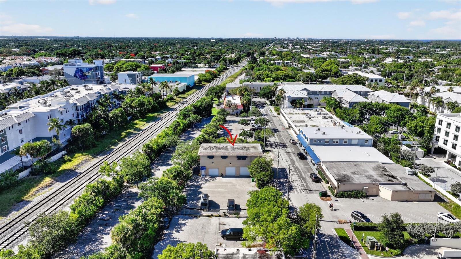 An aerial view shows a two-story commercial building with a red arrow pointing to its roof — 234 NE 4th Avenue, Delray Beach FL 33483, DELRAY BEACH, FL