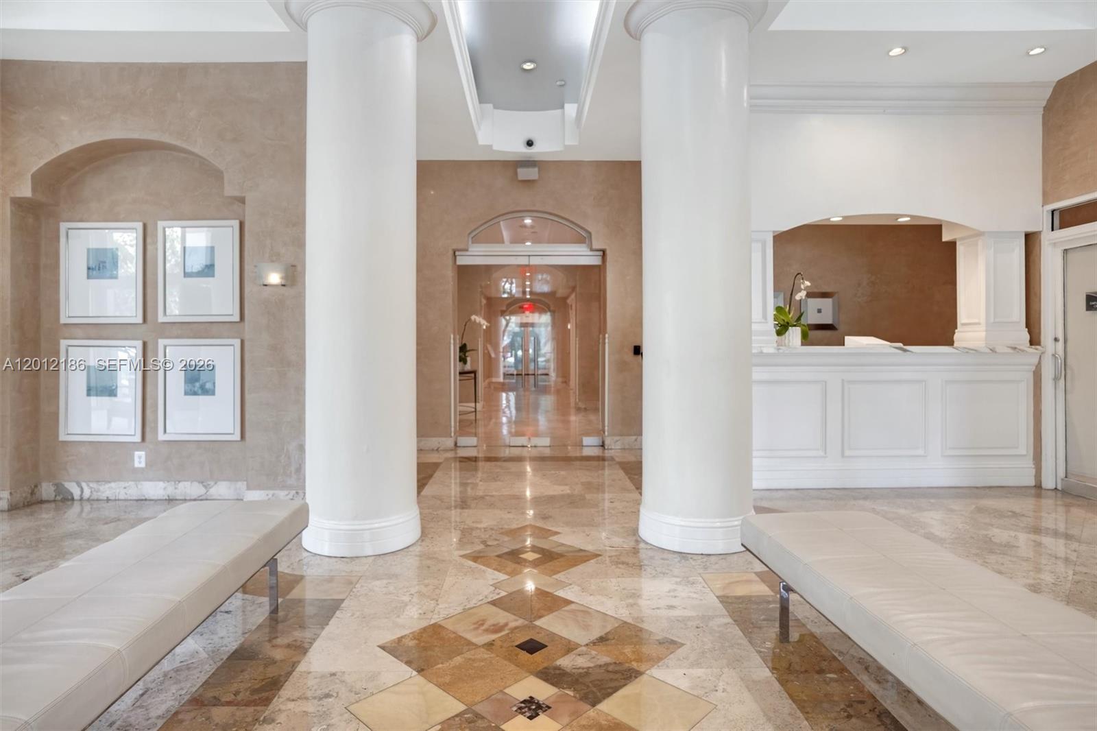 A lobby features two large white columns, tiled floors, and a reception desk — 770 Claughton Island Dr # 1114, Miami FL 33131, MIAMI, FL
