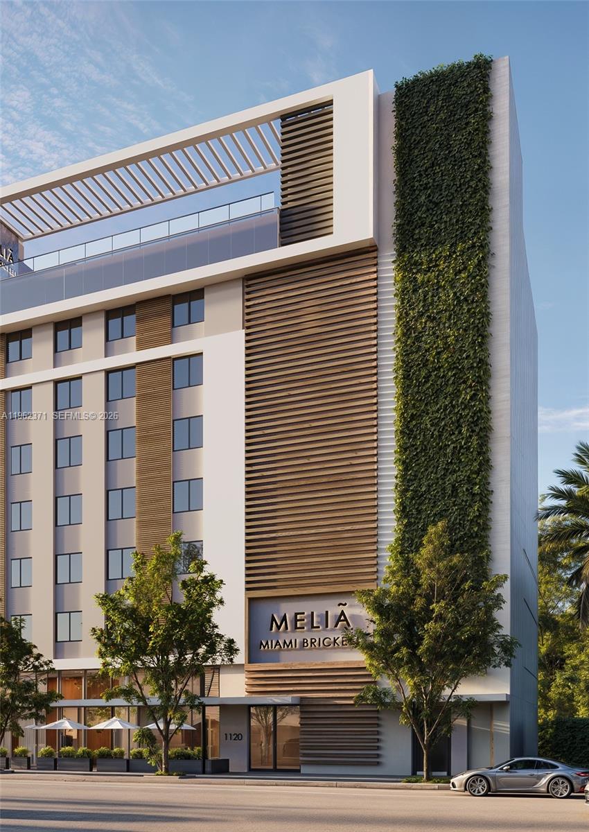 This is a rendering of the exterior of a modern hotel building with vertical greenery — 1136 SW 3 Ave # 409, Miami FL 33130, MIAMI, FL