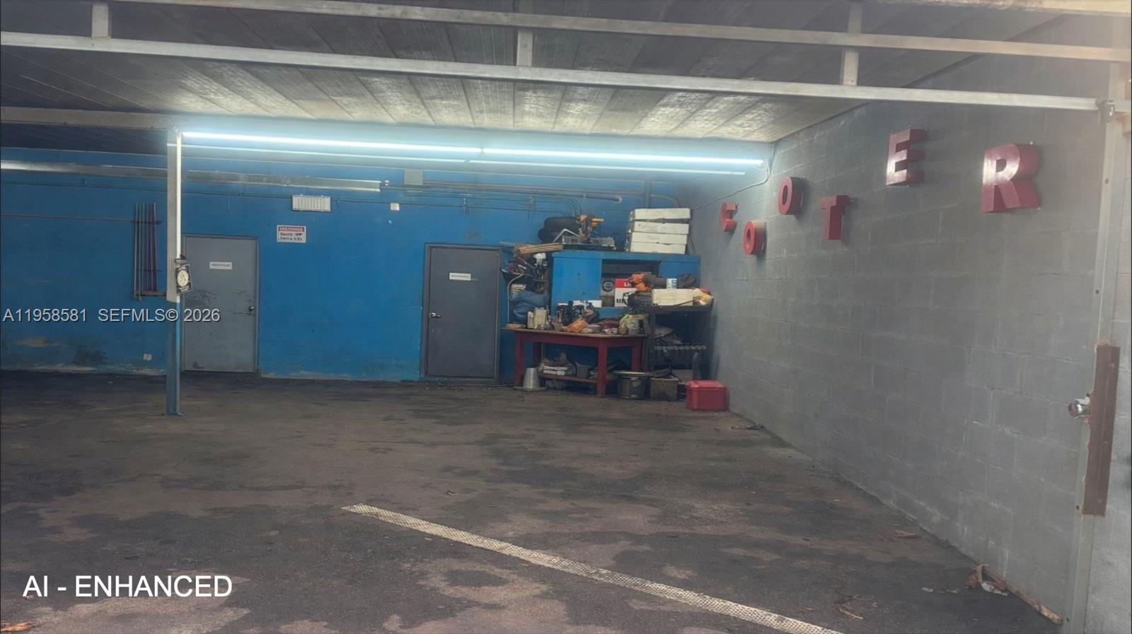 A covered outdoor parking or storage area with blue walls and red lettering — 419 NW 79th St, Miami FL 33150, MIAMI, FL