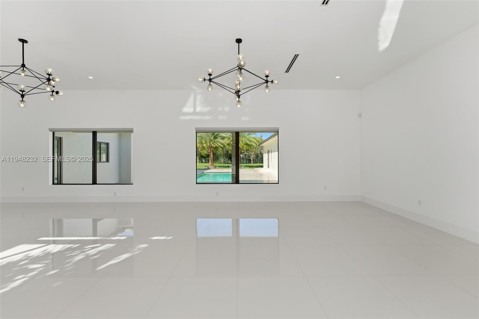 A modern single-story house features a large concrete paver driveway with artificial turf joints — 10005 SW 66th St, Miami FL 33173, MIAMI, FL