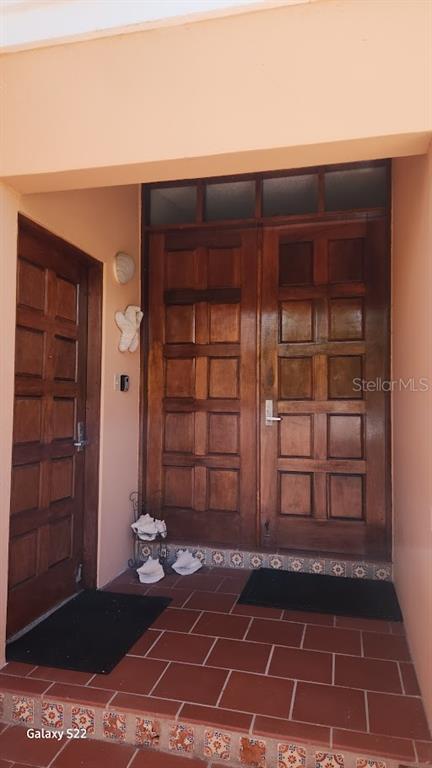 A covered entryway features a tiled floor, two wooden doors, and decorative seashell accents — 806 S FAIRWAY COURTS UNIT 806, PALMAS DEL MAR, HUMACAO, PR