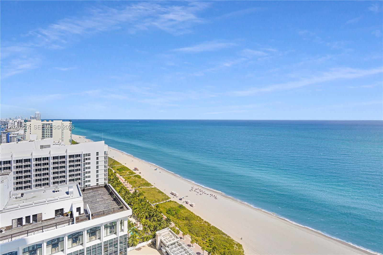 An elevated view of a sandy beach and ocean next to a high-rise building — 4779 Collins Ave # 2908, Miami Beach FL 33140, MIAMI BEACH, FL