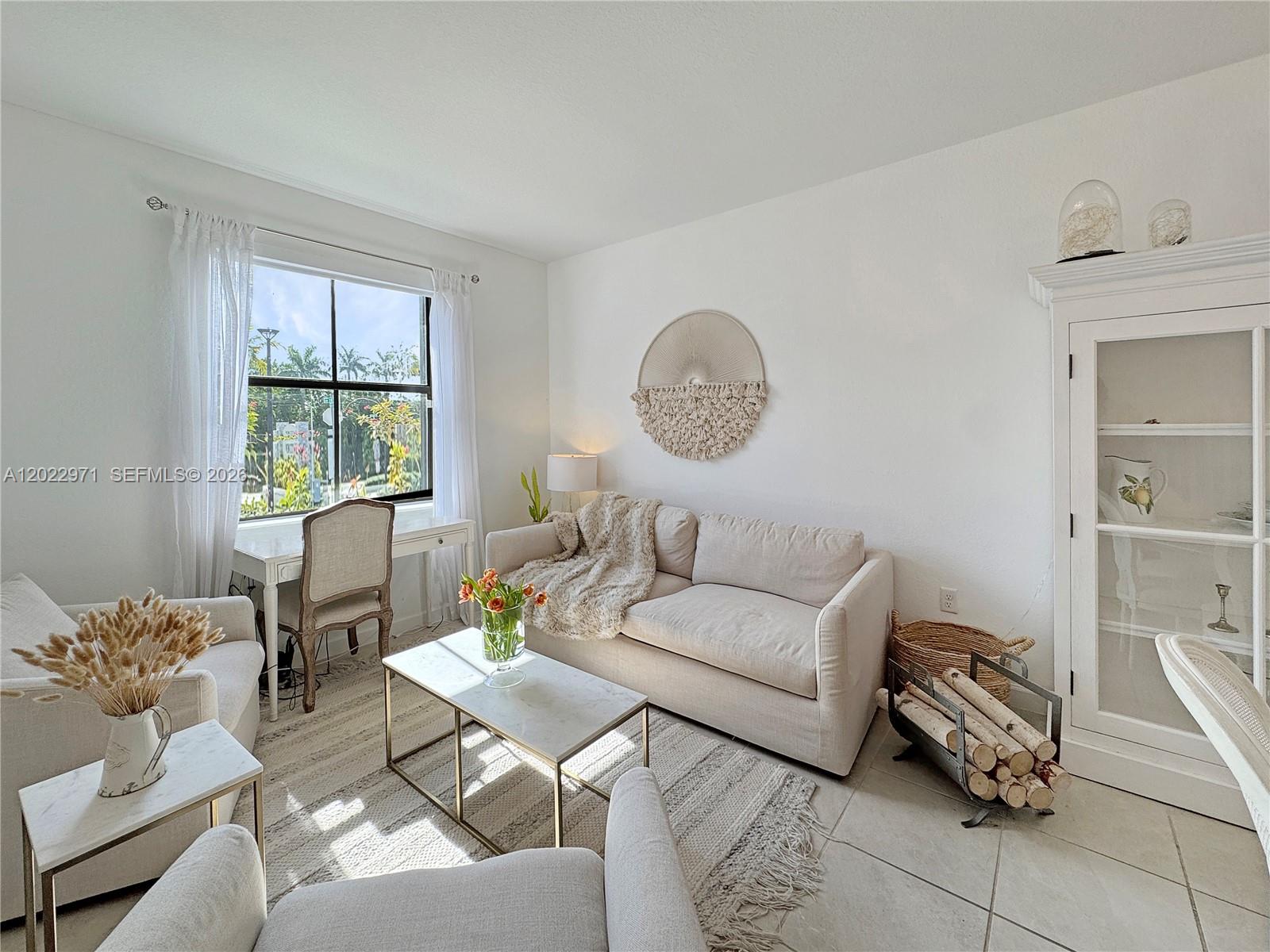 A bright living room features a sofa, armchairs, a coffee table, and a window desk — 14813 SW 183rd Ter # 14813, Miami FL 33187, MIAMI, FL
