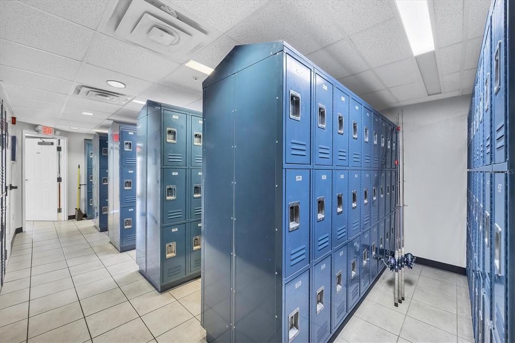 A room with rows of blue metal lockers and fishing rods leaning against the wall — 1780 PHILLIPPI SHORES DRIVE UNIT E1-46, SARASOTA, FL