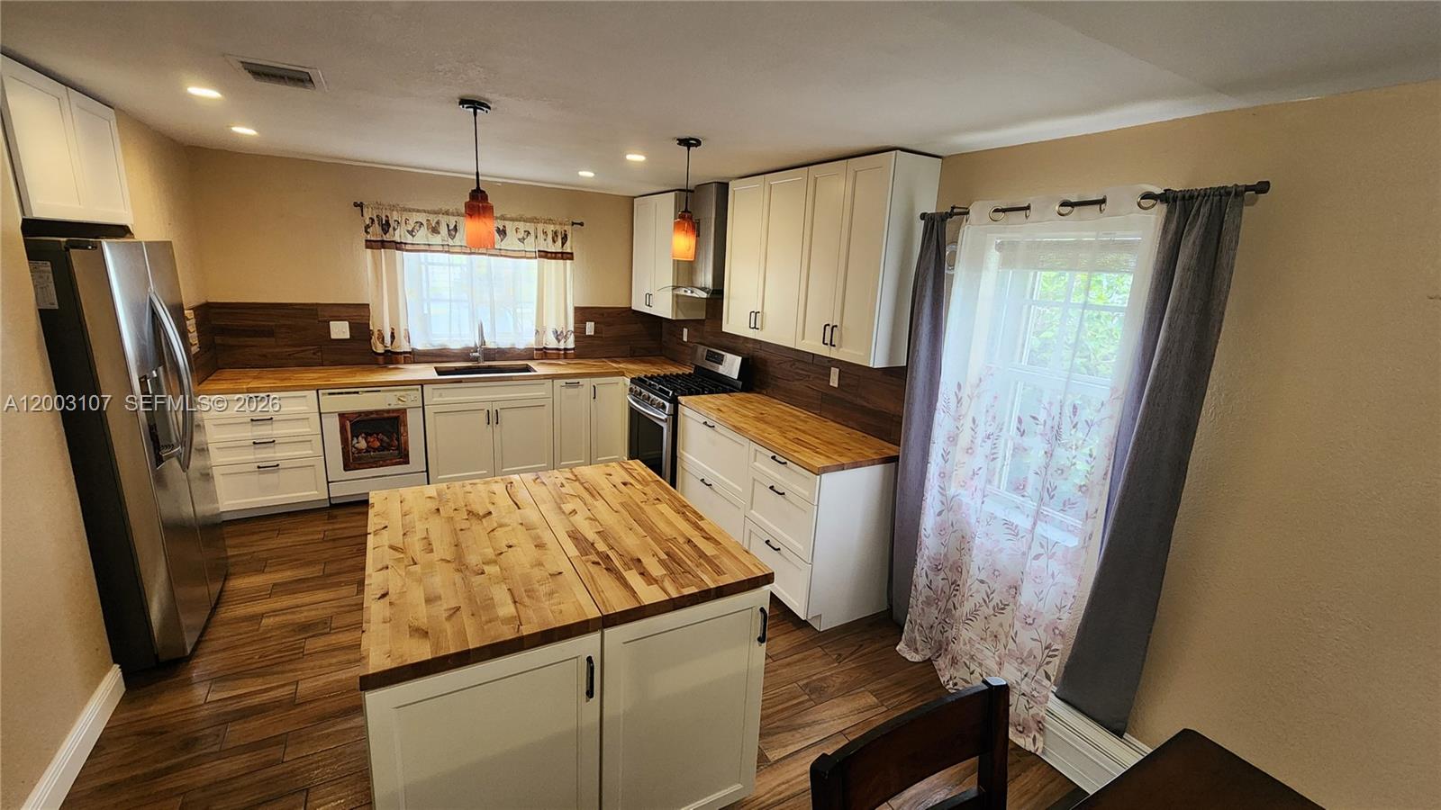 A brown single-story house features a paved driveway and a metal gate — 20301 SW 105th Ave, Cutler Bay FL 33189, CUTLER BAY, FL