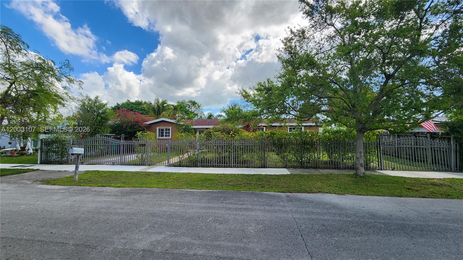 A brown, single-story house with a white front door and a concrete walkway — 20301 SW 105th Ave, Cutler Bay FL 33189, CUTLER BAY, FL