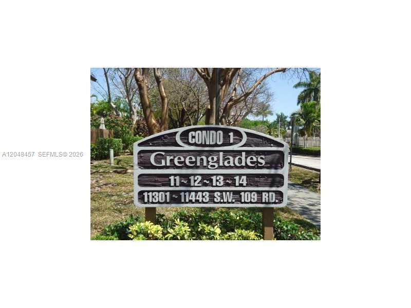 A sign for Greenglades Condo 1 stands outdoors near trees and a sidewalk — 11361 SW 109th Rd # 58D, Miami FL 33176, MIAMI, FL