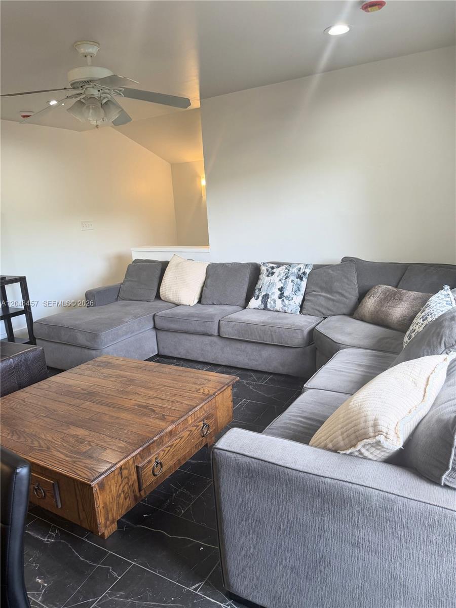 A living room features a large gray sectional sofa, a wooden coffee table, and dark tile flooring — 11361 SW 109th Rd # 58D, Miami FL 33176, MIAMI, FL