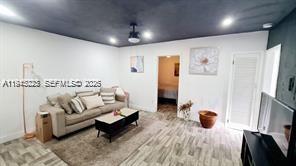 A living room features a beige sofa, a coffee table, and a dark gray ceiling — 88 NE 68th Ter # 88, Miami FL 33138, MIAMI, FL