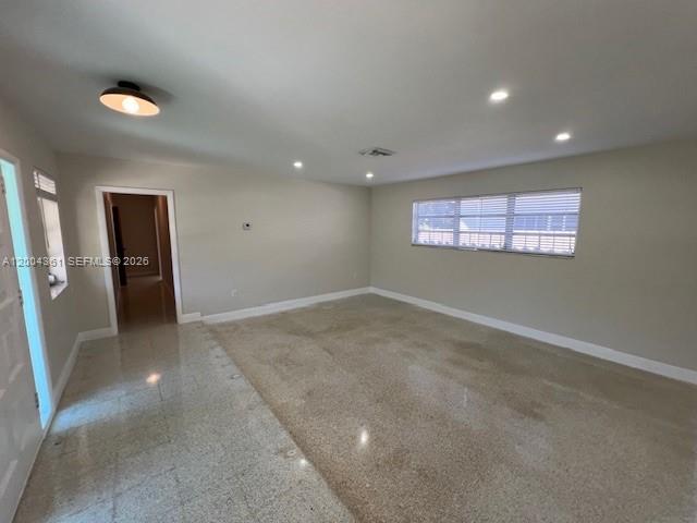 An empty room features light-colored walls, recessed lighting, and a polished terrazzo floor — 2500 SW 58th Ave, Miami FL 33155, MIAMI, FL
