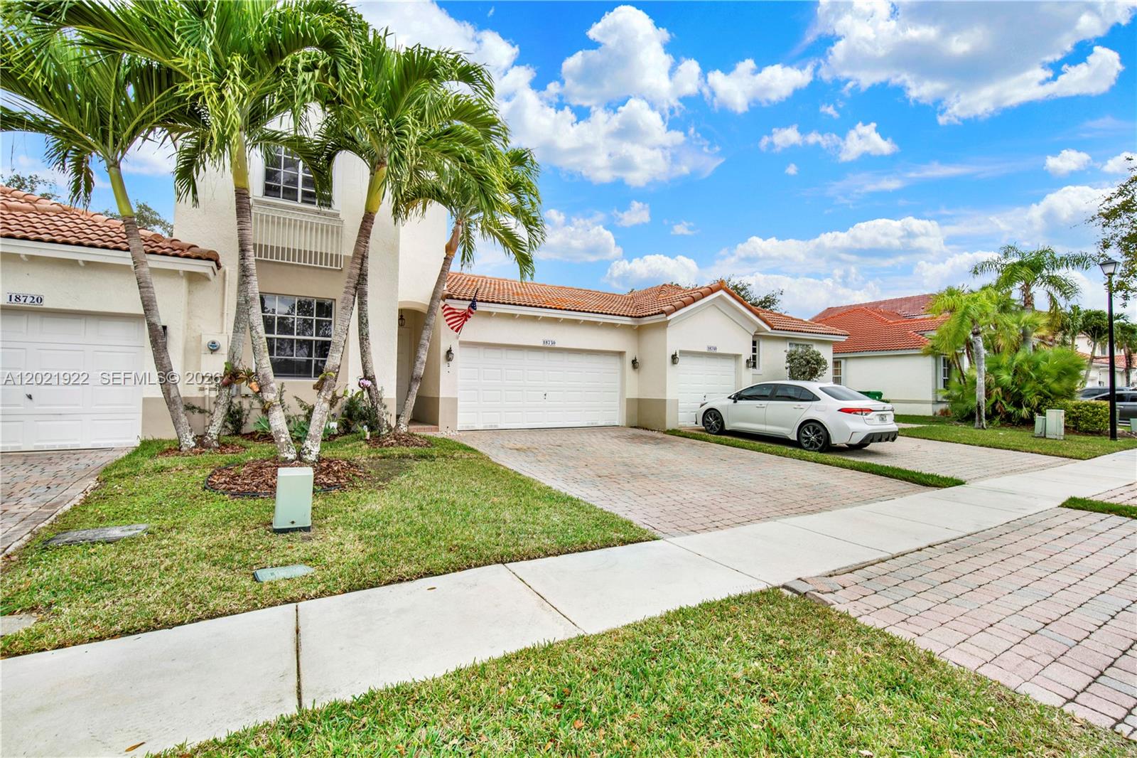 A multi-story residential building with palm trees, a paved driveway, and a white sedan — 18730 SW 25th Ct, Miramar FL 33029, MIRAMAR, FL