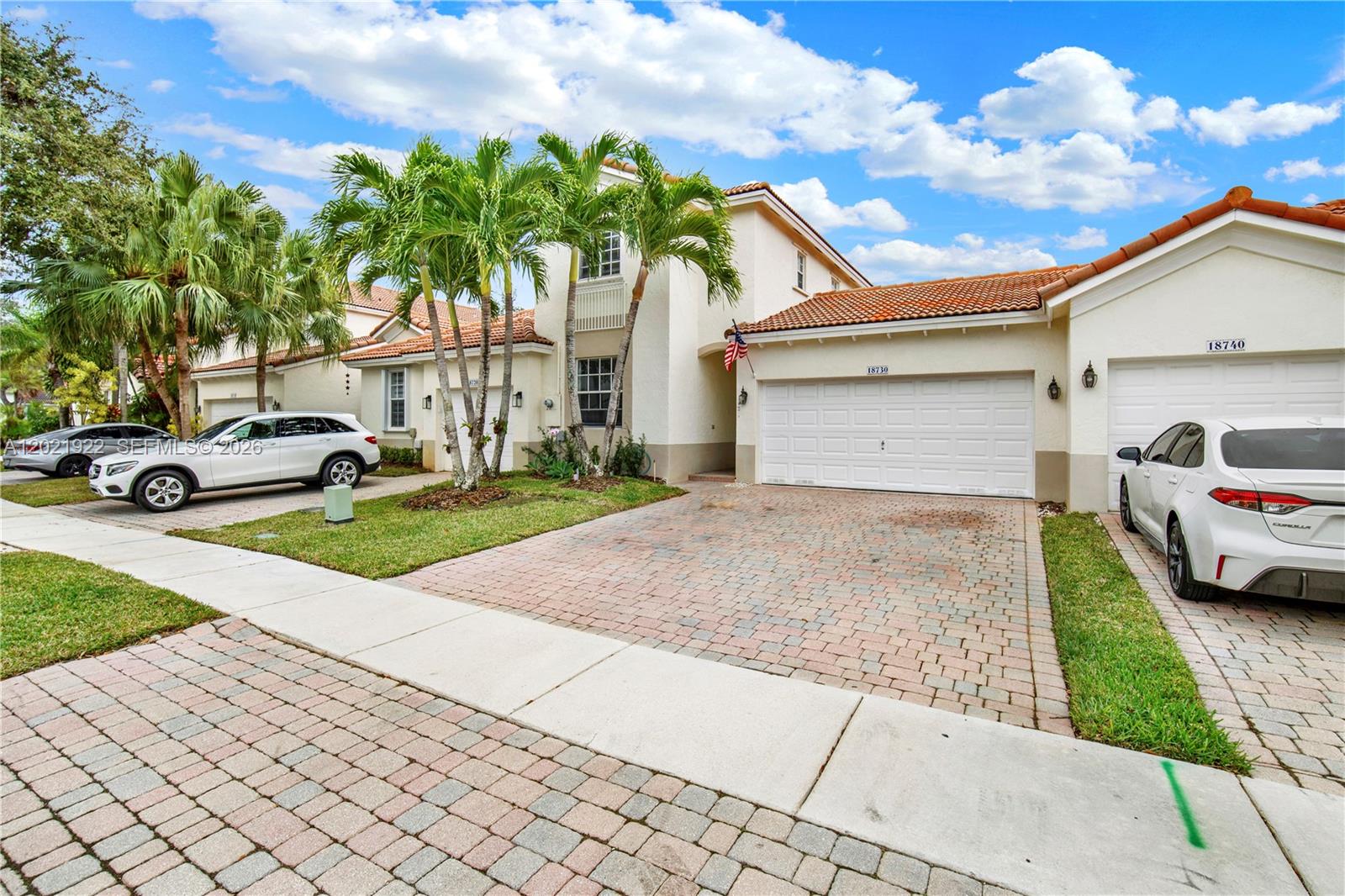 A two-story suburban house features a paved driveway, a two-car garage, and palm trees — 18730 SW 25th Ct, Miramar FL 33029, MIRAMAR, FL
