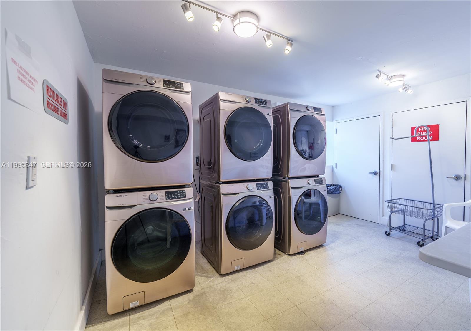 A laundry room features three stacked sets of Samsung washers and dryers on tiled flooring — 720 Collins Ave # 506, Miami Beach FL 33139, MIAMI BEACH, FL