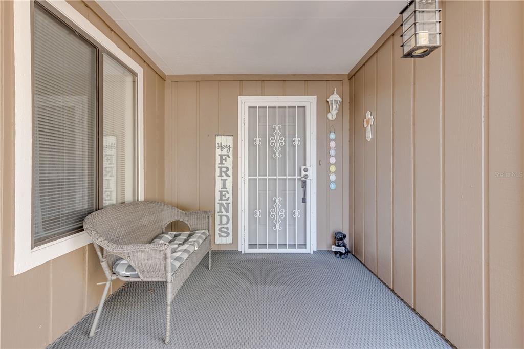 An aerial view shows a residential building with a central courtyard near a lake — 49 CROOKED PINE ROAD, PORT ORANGE, FL