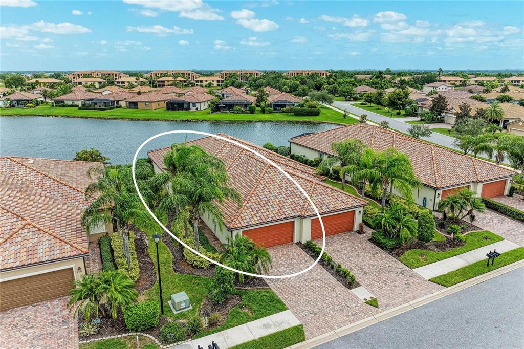 An aerial view of a residential home with a tiled roof and a two-car garage — 6623 CANDLESTICK DRIVE, BRADENTON, FL