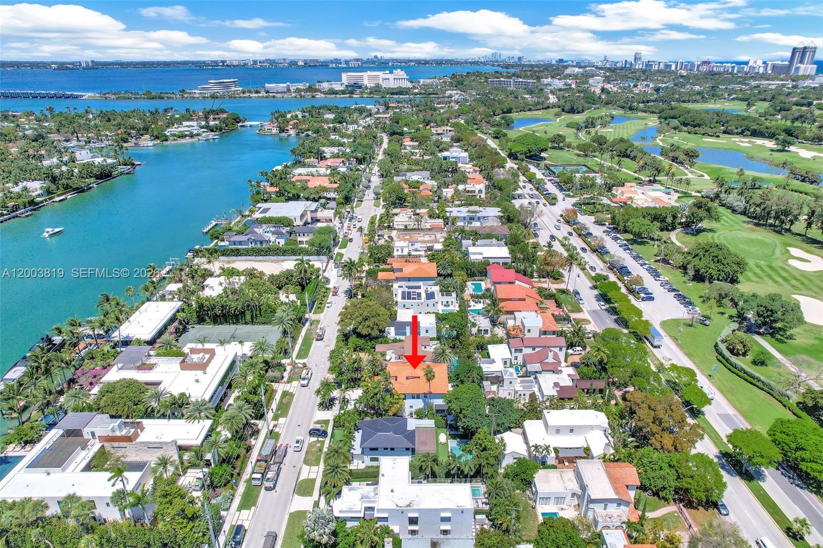 An aerial view shows a residential neighborhood with a red-roofed house marked by an arrow — 2143 N Bay Rd, Miami Beach FL 33140, MIAMI BEACH, FL