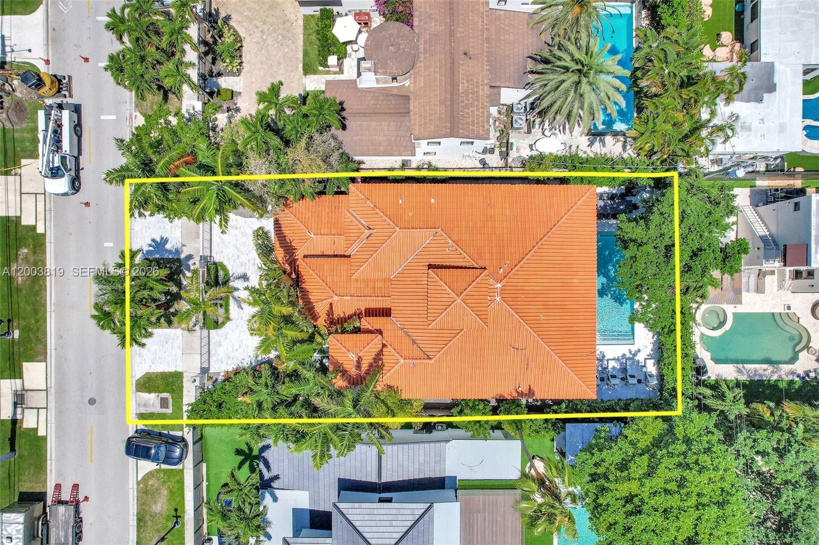 An aerial view shows a house with a terracotta tile roof and a backyard pool — 2143 N Bay Rd, Miami Beach FL 33140, MIAMI BEACH, FL