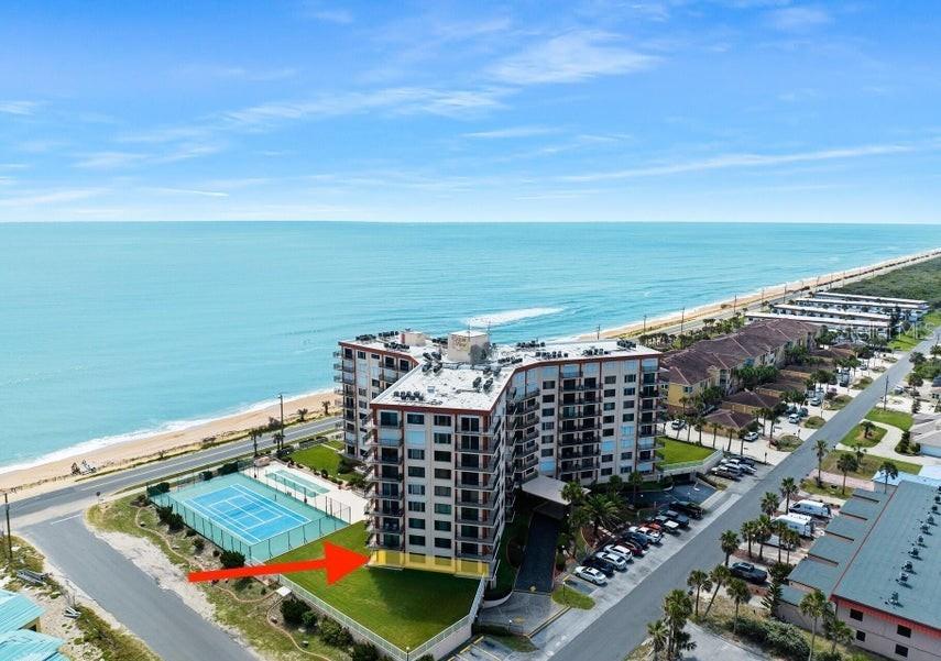 An aerial view of a beachfront condominium building with a tennis court and parking lot — 3600 S OCEAN SHORE BOULEVARD UNIT 111, FLAGLER BEACH, FL
