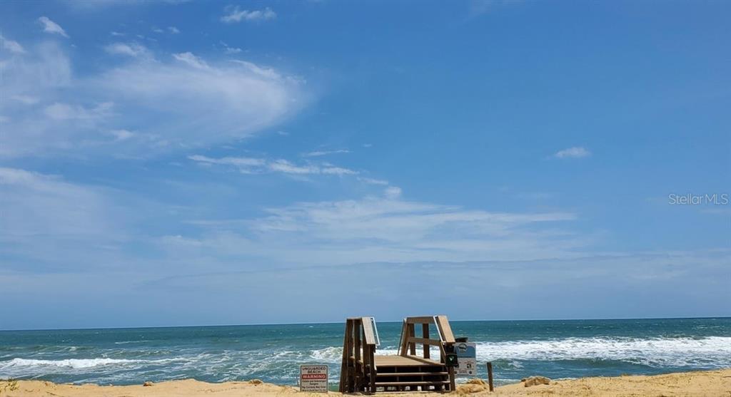 A wooden beach access staircase sits on a sandy dune overlooking the ocean — 3600 S OCEAN SHORE BOULEVARD UNIT 111, FLAGLER BEACH, FL