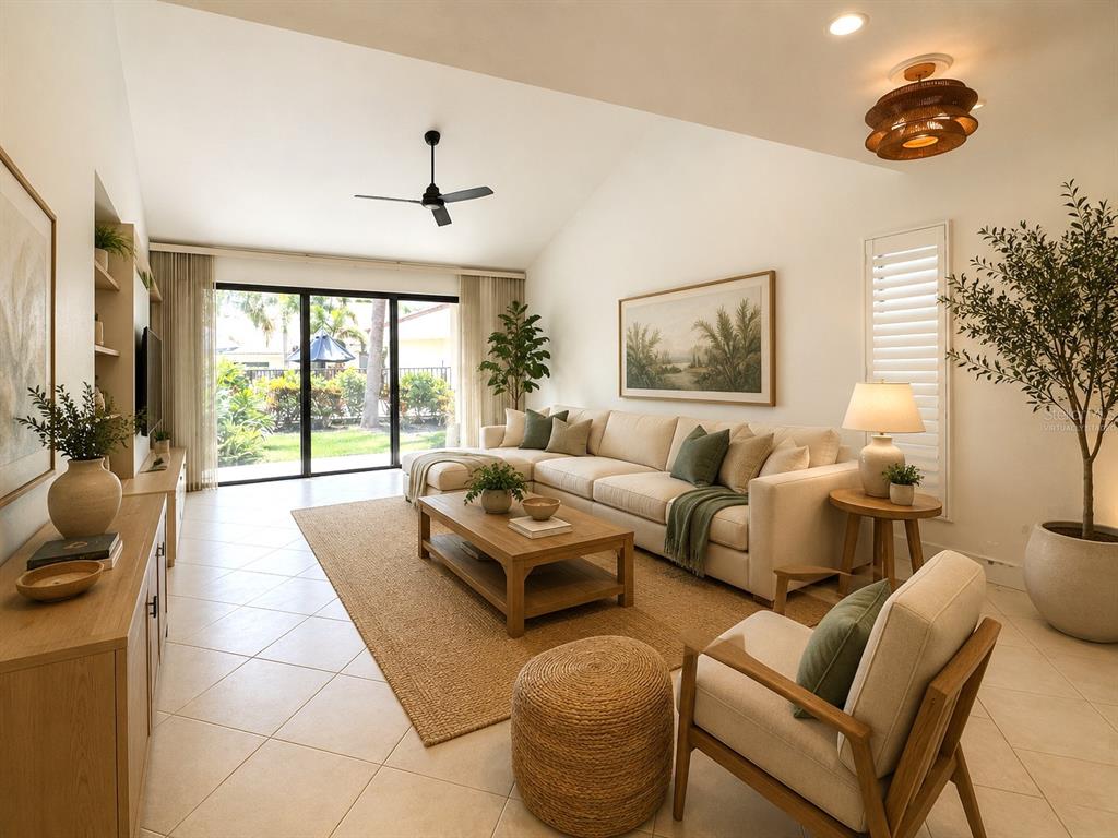 A bright living room features a beige sectional sofa, a wooden coffee table, and tile flooring — 5312 HUNTINGWOOD COURT UNIT 39, SARASOTA, FL