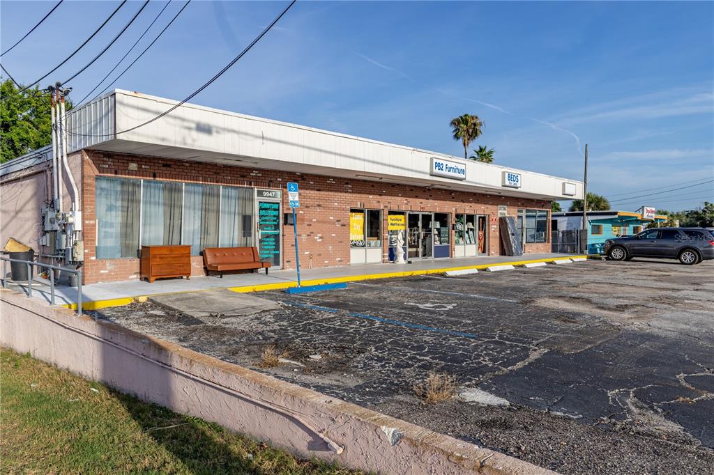 A single-story brick commercial building with a parking lot and storefront signage — 9933 SEMINOLE BOULEVARD, SEMINOLE, FL