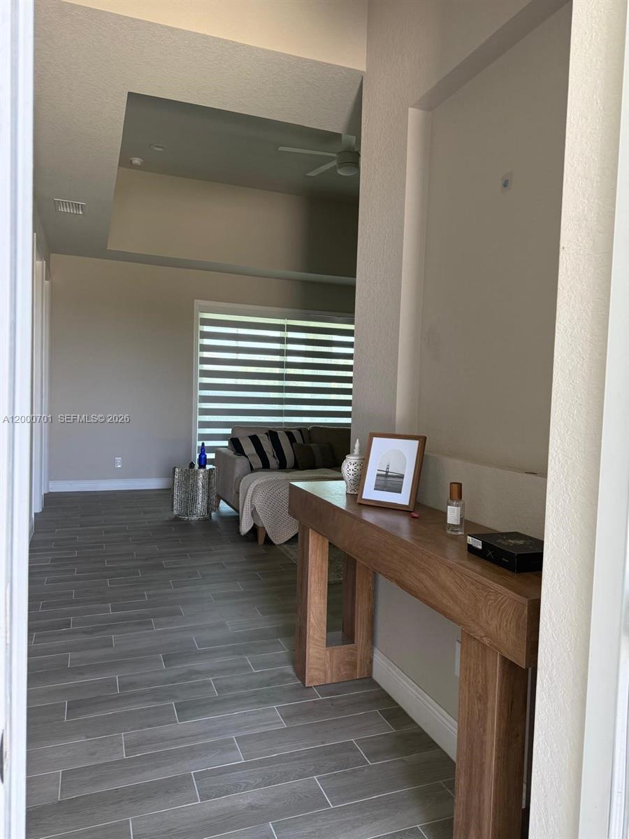 A console table sits in a hallway leading to a living room with wood-look flooring — 368 NEIGHBORLY RD, La Belle FL 33935, LA BELLE, FL