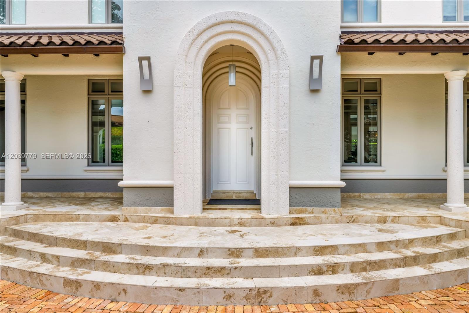 The exterior entrance features a white arched doorway, stone steps, and two flanking columns — 165 Paloma Dr, Coral Gables FL 33143, CORAL GABLES, FL