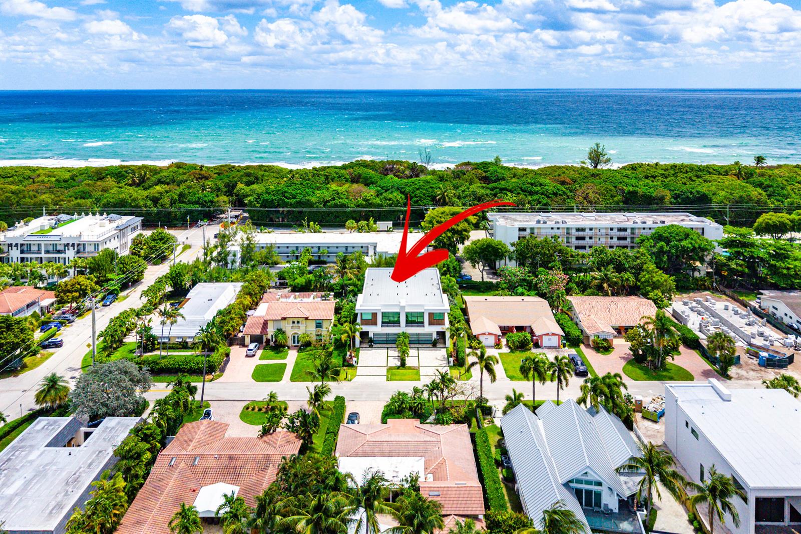 An aerial view shows a modern two-story house with a flat roof near the ocean — 320 NE Wavecrest Way, Boca Raton FL 33432, BOCA RATON, FL