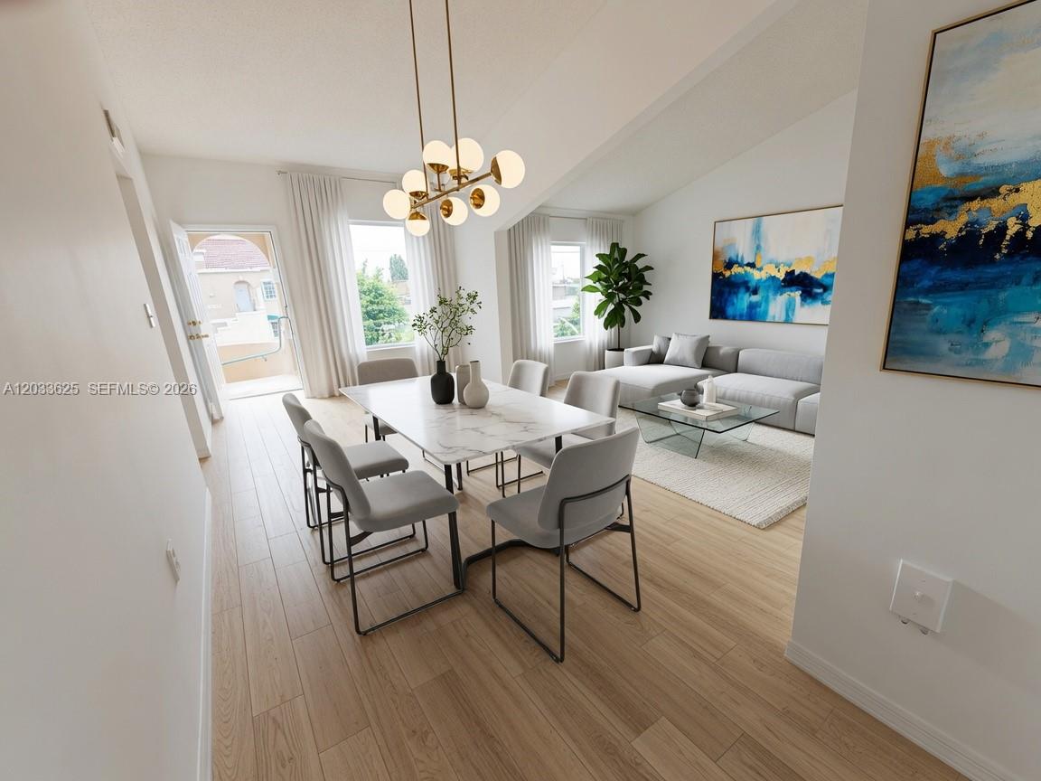 A bright dining and living area features a marble table, modern chandelier, and light flooring — 13120 SW 64th Ter # 1504, Miami FL 33183, MIAMI, FL
