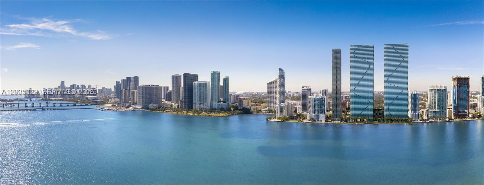 An aerial view shows a waterfront city skyline with numerous high-rise buildings under a clear sky — 700 NE 24 # 2206, Miami FL 33137, MIAMI, FL