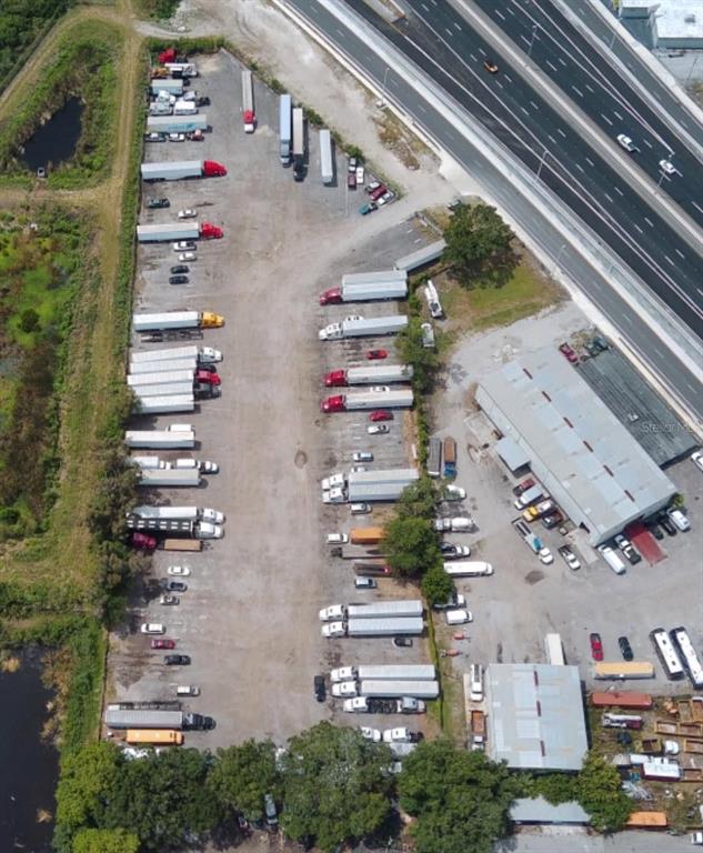 An aerial view shows a commercial truck parking lot adjacent to a highway — 12355 US HWY 19 N, CLEARWATER, FL