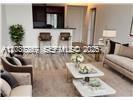 This rendering shows a modern living room with a kitchen breakfast bar and neutral furniture — 888 S Douglas Rd # 1602, Coral Gables FL 33134, CORAL GABLES, FL