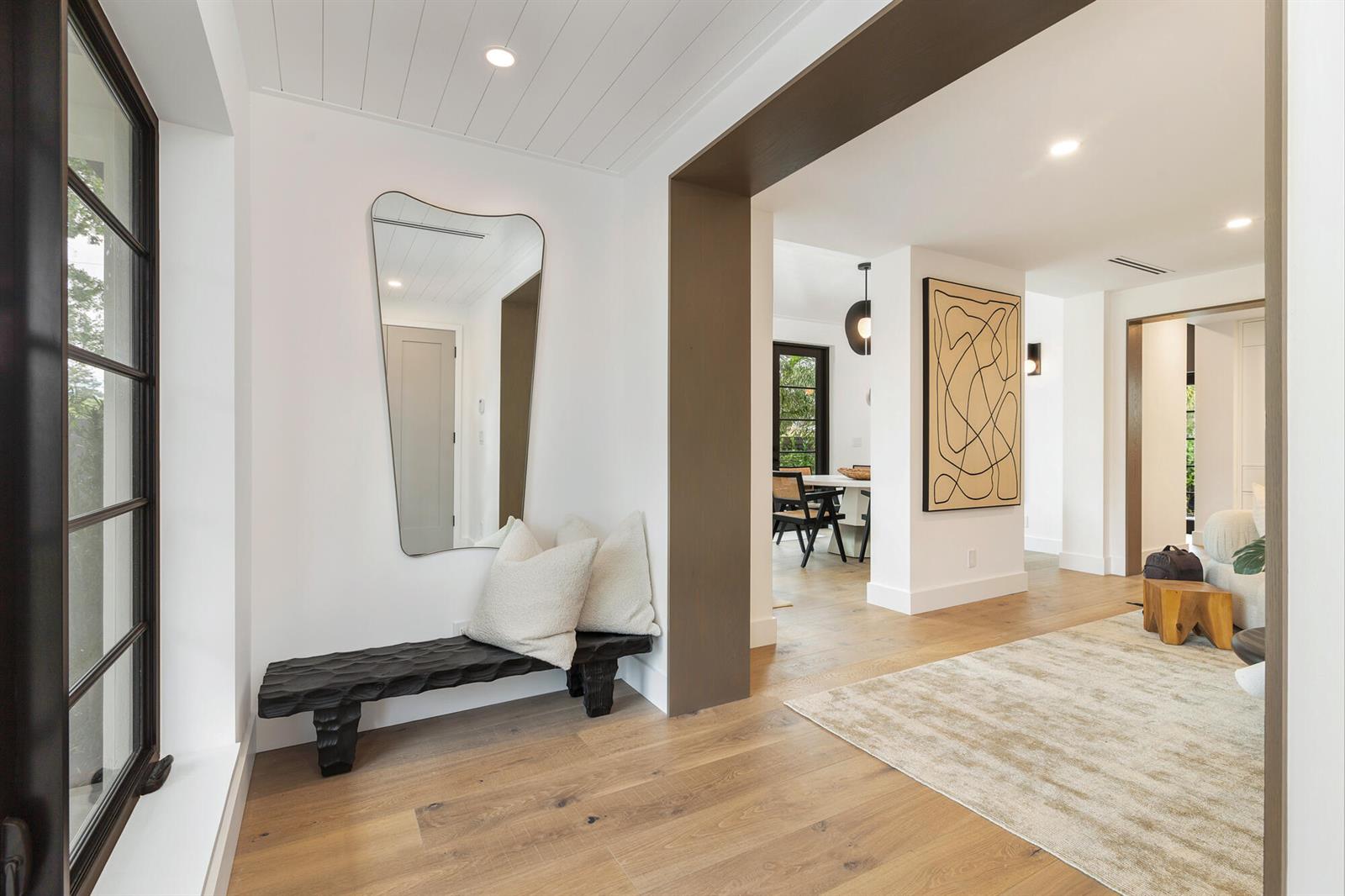 A modern white house features a paved driveway, two small palm trees, and dark-framed windows — 263 Alhambra Place, West Palm Beach FL 33405, WEST PALM BEACH, FL