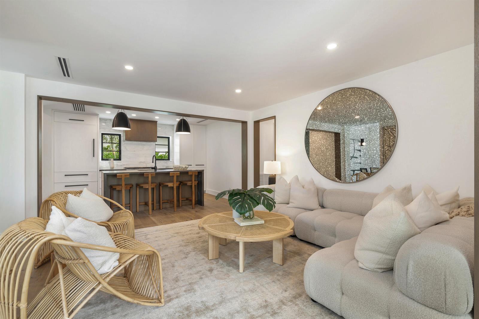 A bright dining and living area features a round white table, cane chairs, and black-framed doors — 263 Alhambra Place, West Palm Beach FL 33405, WEST PALM BEACH, FL