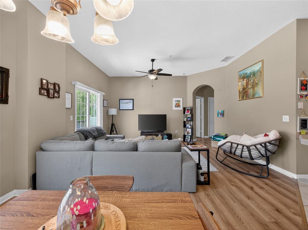 A living room with a gray sectional sofa, a rocking chair, and a television — 2811 SAN JACINTO CIRCLE, SANFORD, FL