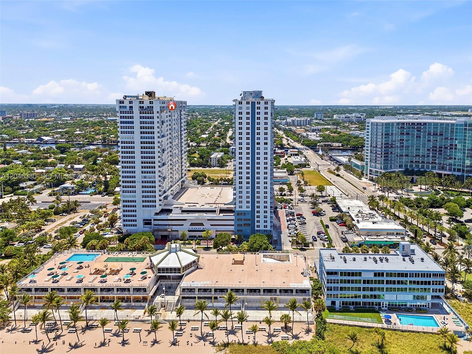 An aerial view shows two tall residential towers, a beachside clubhouse, and a swimming pool — 111 N BRINY AVE, Pompano Beach FL 33062, POMPANO BEACH, FL