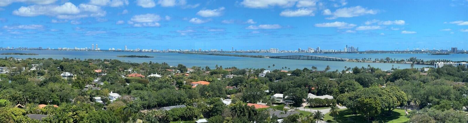 A panoramic view of a lush residential neighborhood overlooking a bay and a distant city — 4770 Biscayne Boulevard # 620, Miami FL 33137, MIAMI, FL