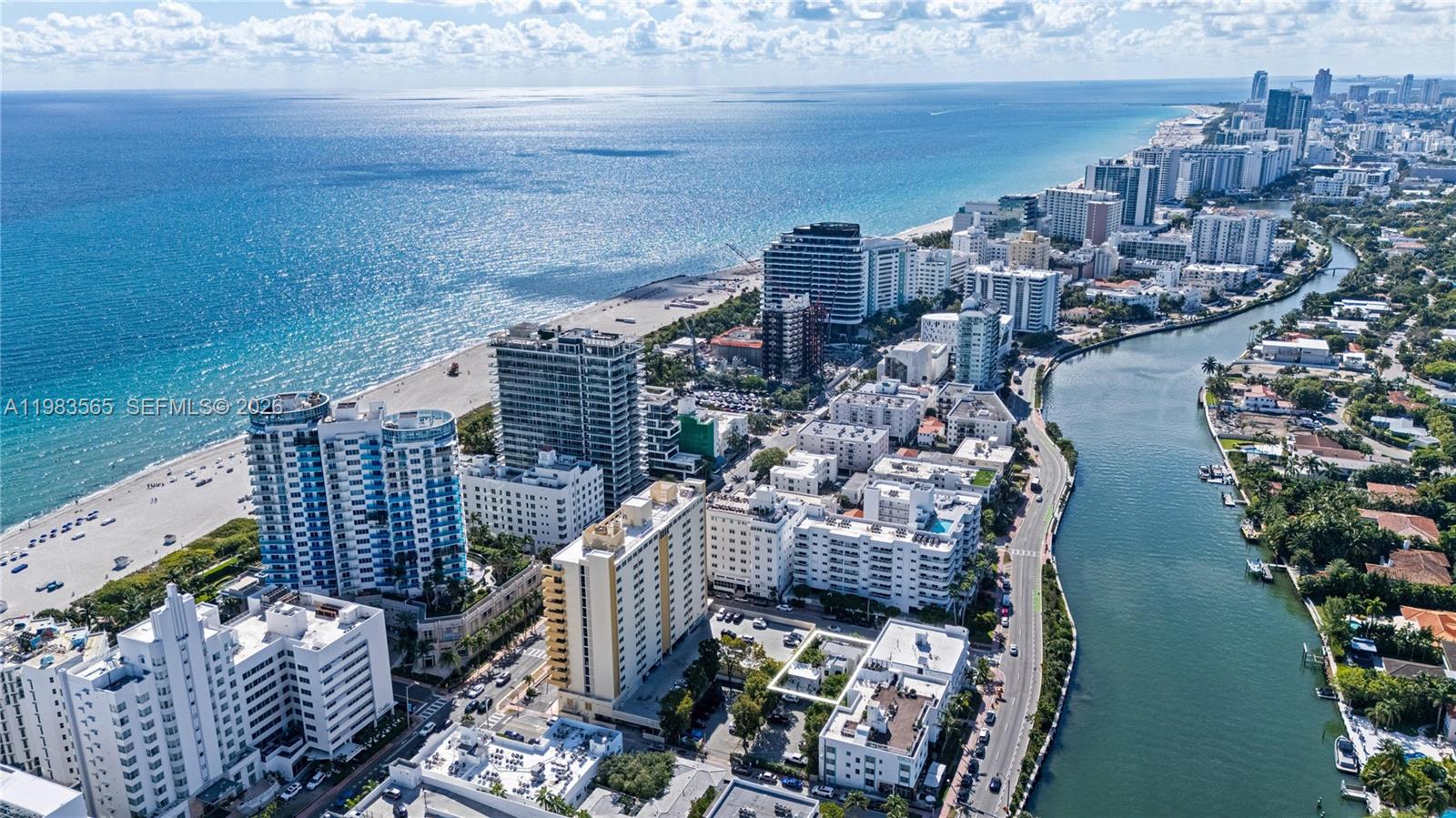 An aerial view shows a coastal city with high-rise buildings, a beach, and a waterway — 237 38th St # 4, Miami Beach FL 33140, MIAMI BEACH, FL